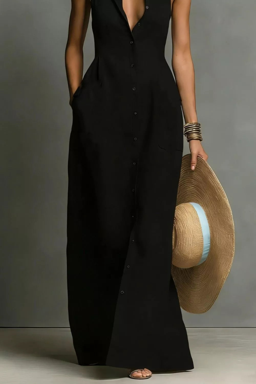 Black button-down sleeveless maxi shirt dress, mid-body view showing the tapered waist and floor-length skirt.