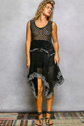 Black open-weave cotton lace handkerchief hem dress, front view showing the round neckline, sleeveless cut, and layered asymmetric lace hem with ruffled trim.