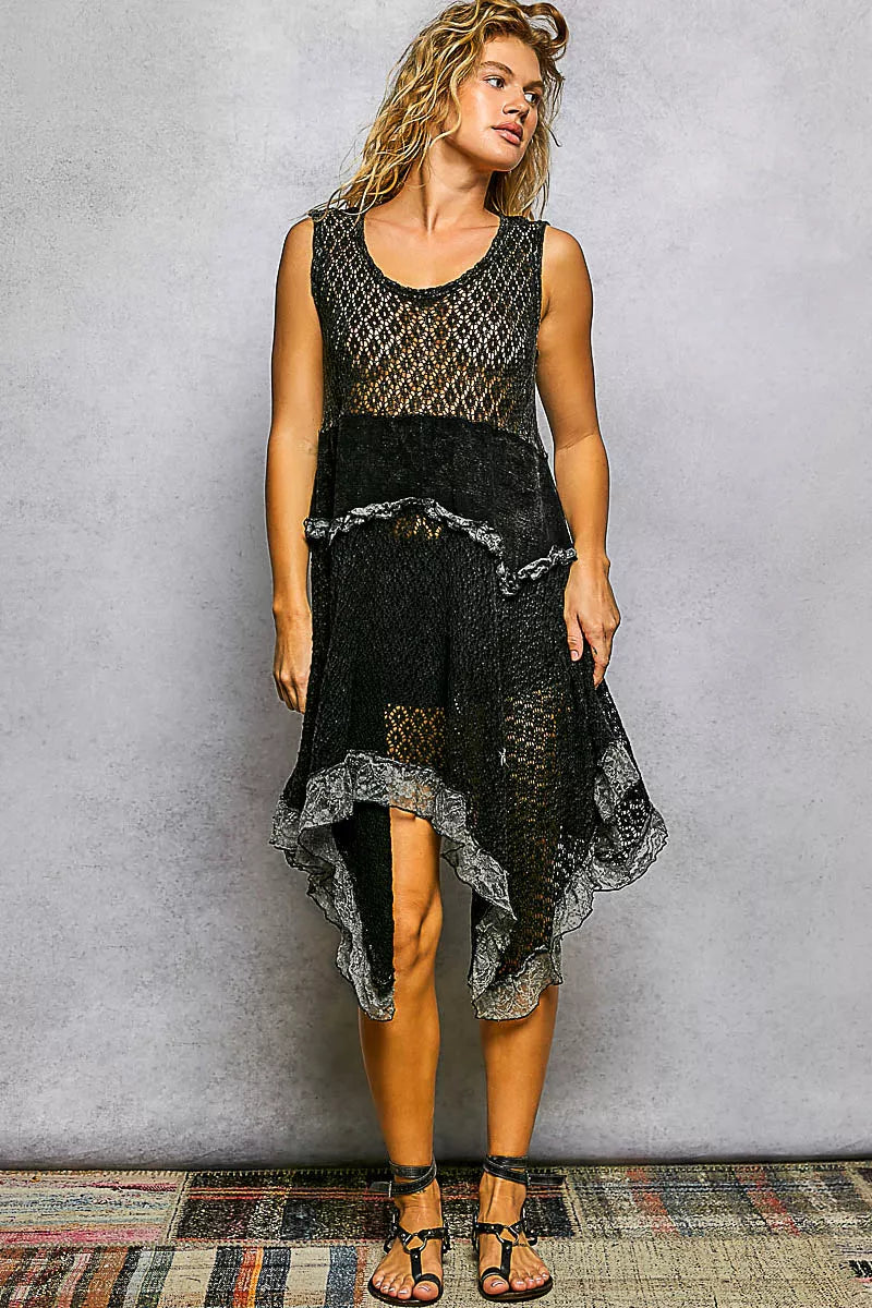 Black open-weave cotton lace handkerchief hem dress, front view showing the round neckline, sleeveless cut, and layered asymmetric lace hem with ruffled trim.