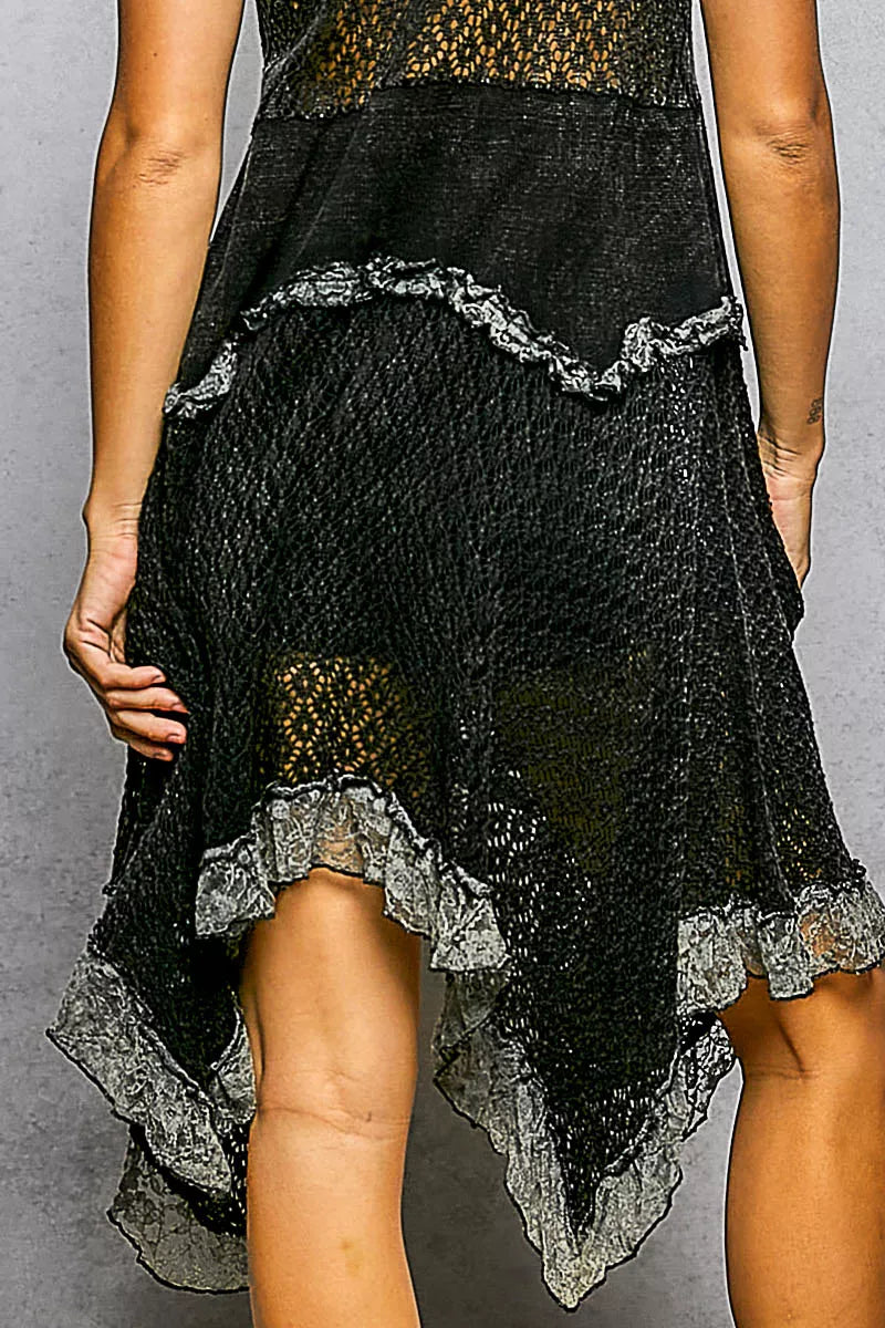Black open-weave cotton lace dress, hem detail close-up showing the ruffled lace trim and layered handkerchief tiers.