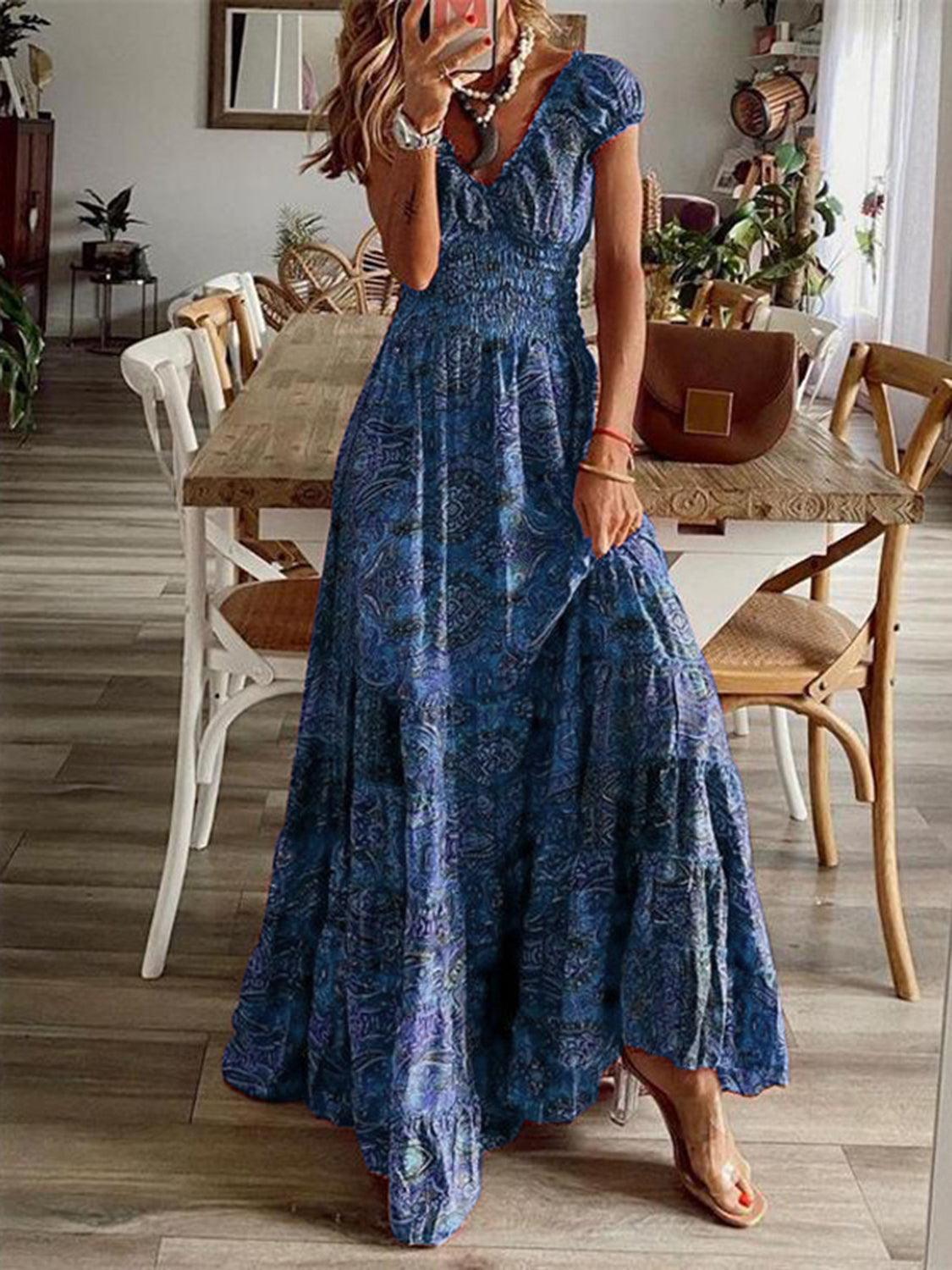 Blue paisley smocked maxi dress, full-length view showing the tiered floor-length skirt.