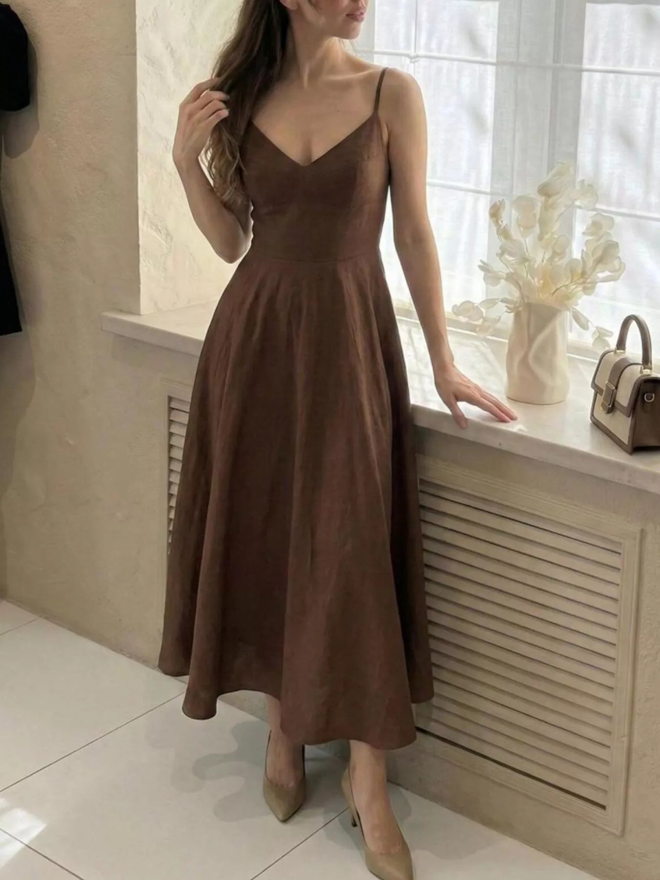 Chocolate Brown Spaghetti Strap Midi Dress, side view showing the V-neckline, spaghetti straps, and the swing of the A-line skirt.