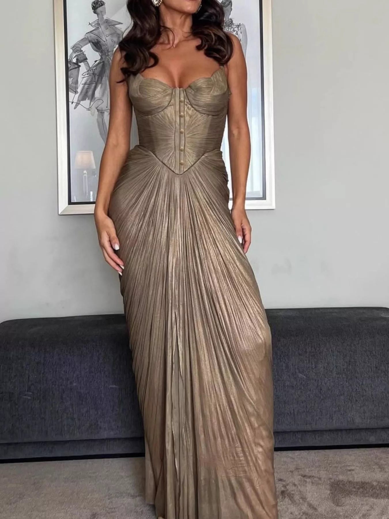 Gold Metallic Pleated Corset Maxi Dress, side view showing the corset shape, spaghetti straps, and side slit through the pleated skirt.