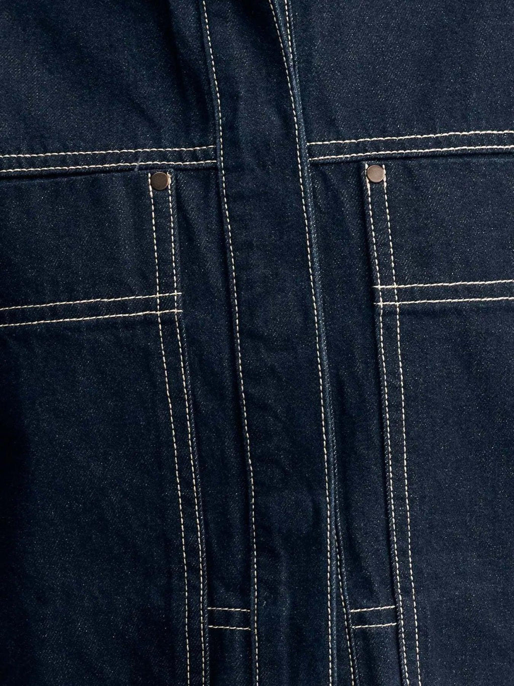 Midnight blue contrast-stitch denim top, side view showing the boxy drop-shoulder cut and cropped hem.