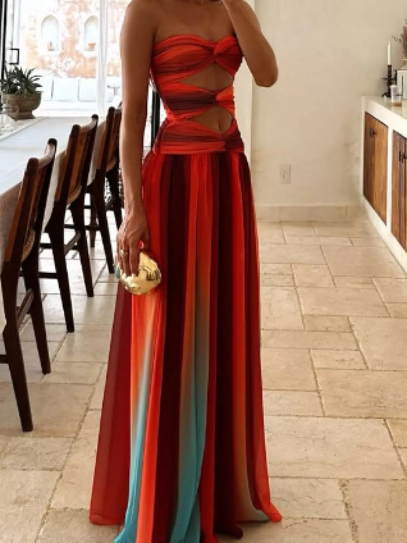 Lower-body view of the Orange Strapless Twisted Cutout Maxi Dress, showing the sheer multi-tonal chiffon skirt in coral, sunset orange, and dusty teal stripes.
