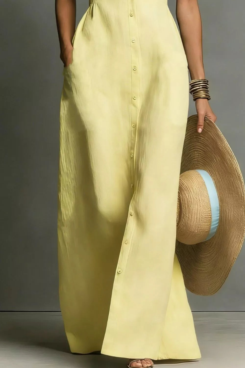 Pastel yellow button-down sleeveless maxi shirt dress, mid-body view showing the fitted waist and button placket.