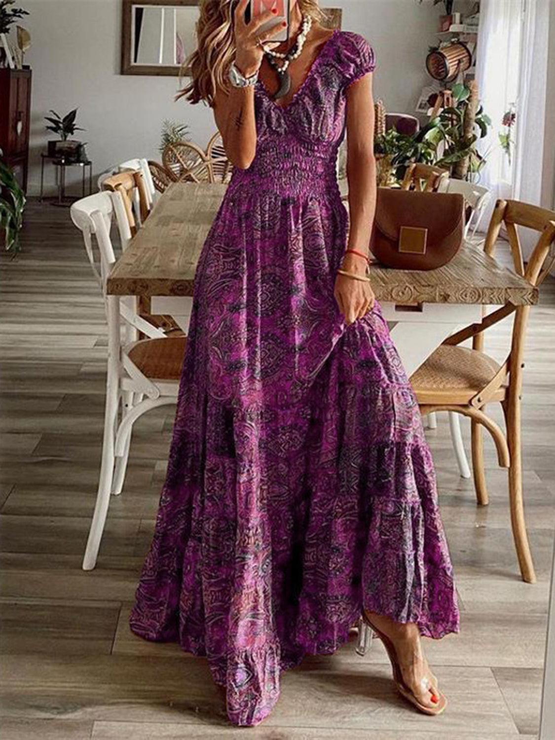 Purple paisley smocked maxi dress, full-length view showing the tiered skirt and bohemian print.