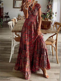 Red paisley smocked V-neck short-sleeve maxi dress, front view showing the smocked bodice, V-neckline, cap sleeves, and tiered floor-length skirt.