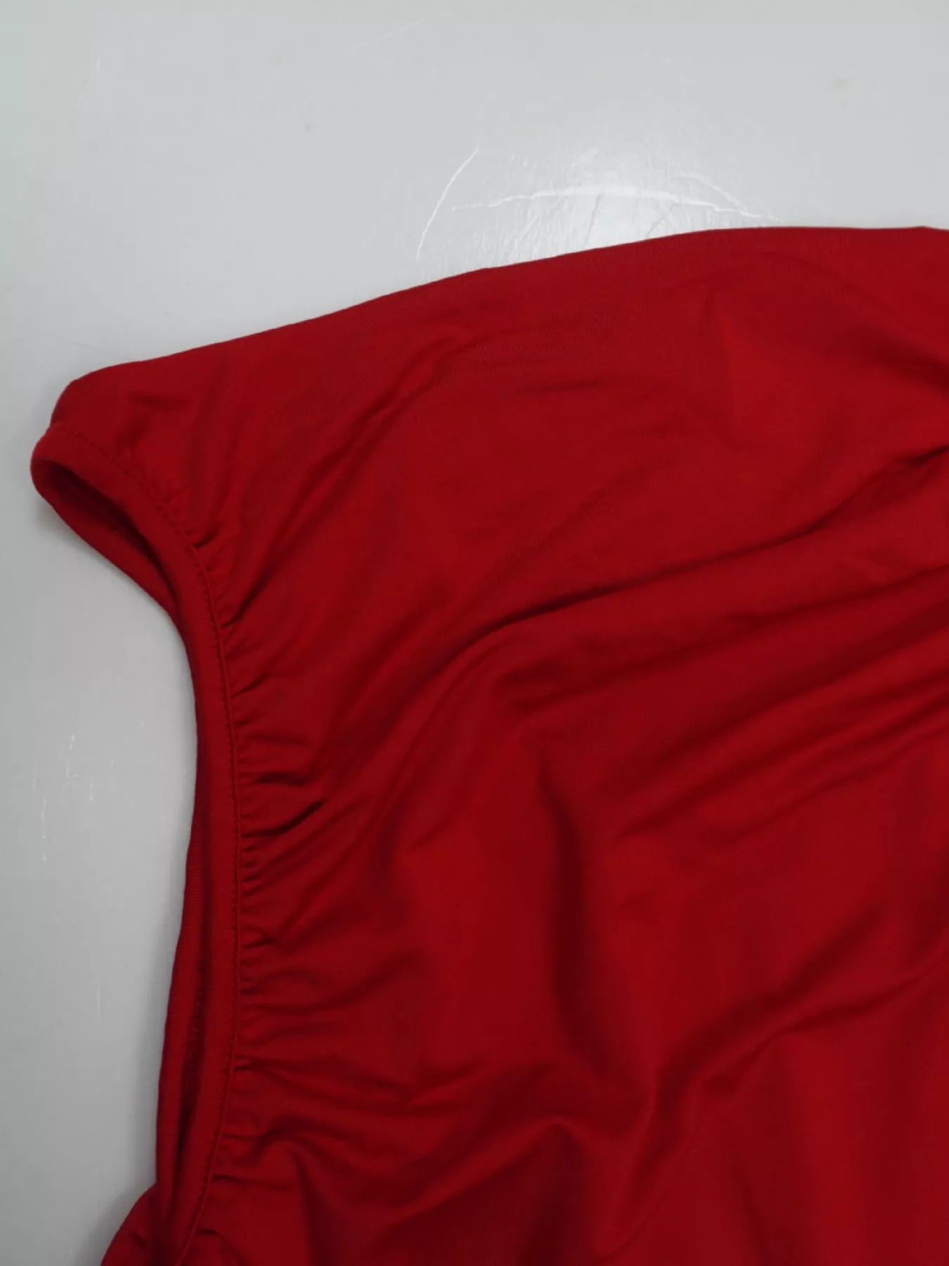 Red ruched bodice drop-waist maxi dress, side view showing the drop-waist seam and the full skirt sweep.