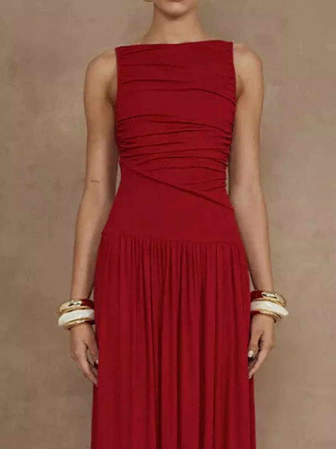 Red ruched sleeveless maxi dress, back view showing the high neckline and the gathered skirt.