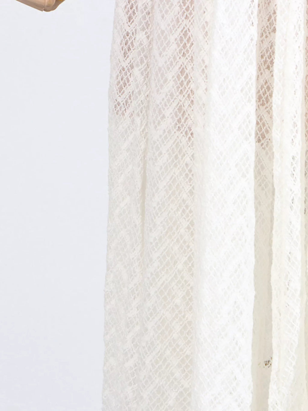 White lace long-sleeve maxi dress, side profile showing the bias drape and floor-length sweep.