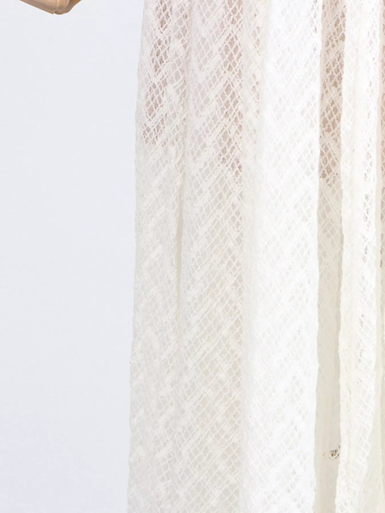 White lace long-sleeve maxi dress, side profile showing the bias drape and floor-length sweep.