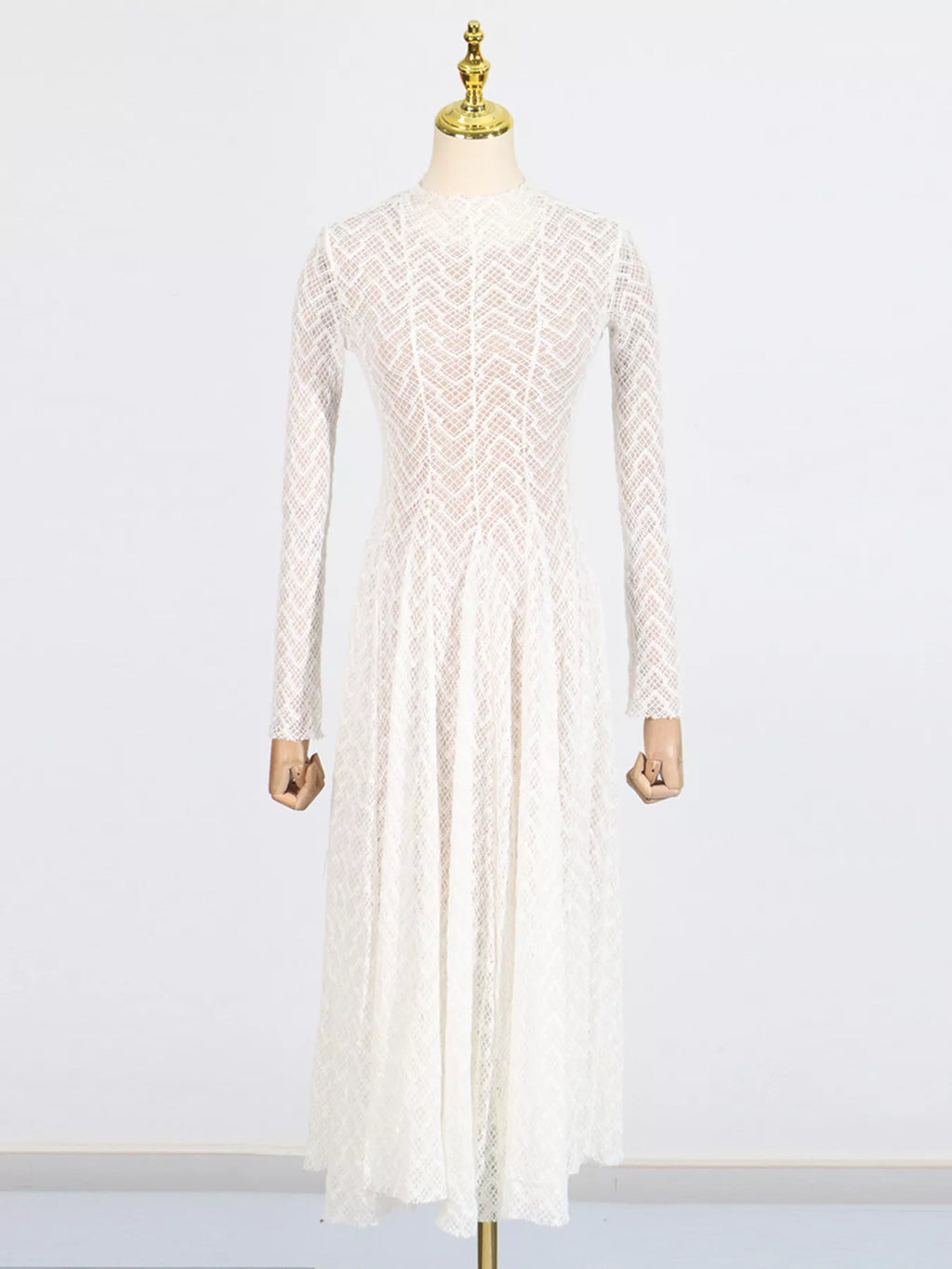 White textured-lace long-sleeve maxi dress, side view showing the bias-cut silhouette and floor-length skirt.