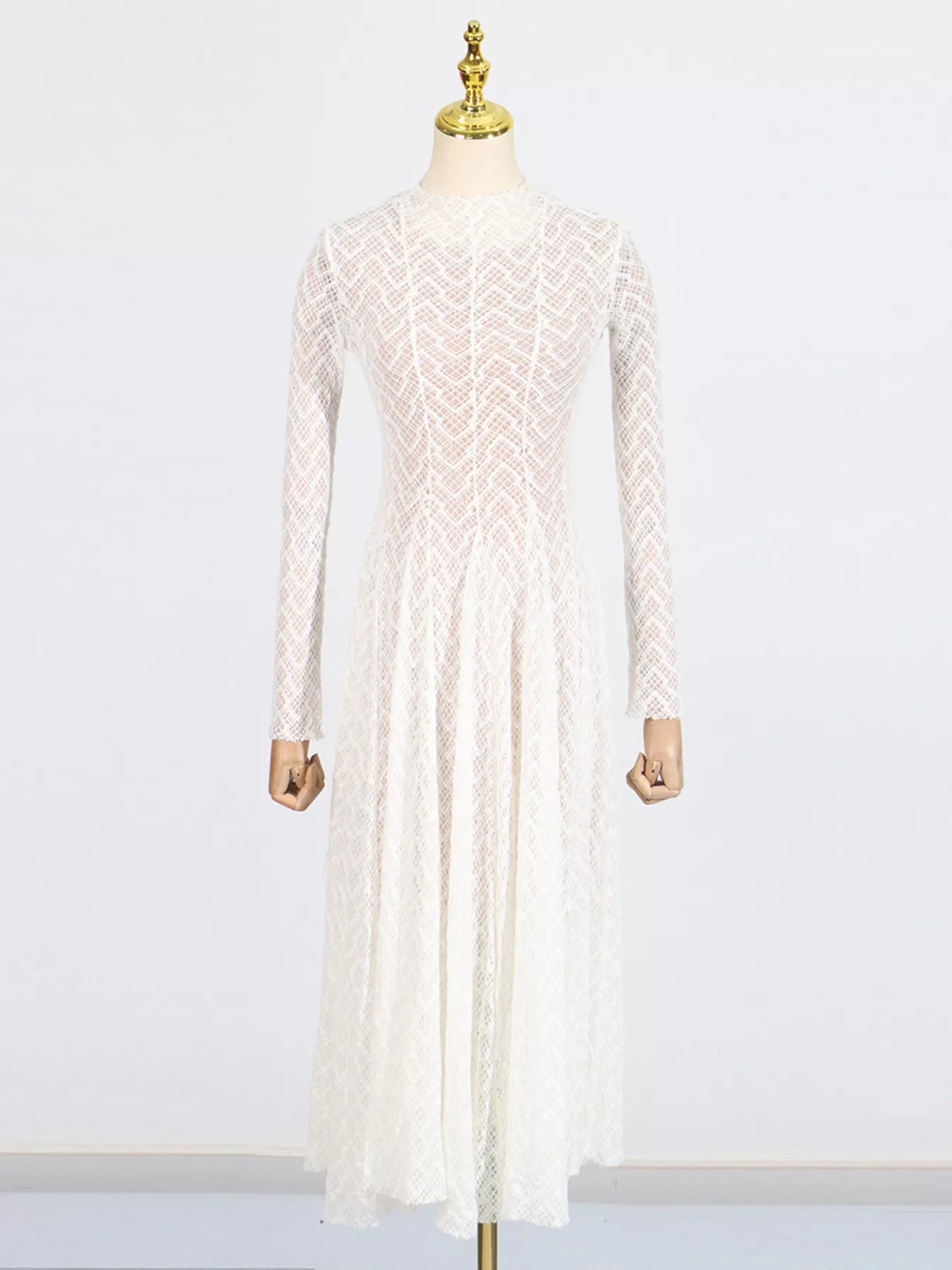 White textured-lace long-sleeve maxi dress, side view showing the bias-cut silhouette and floor-length skirt.