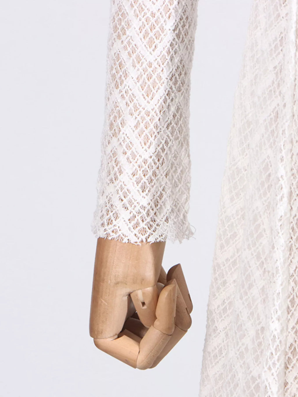 White lace mock-neck maxi dress, bodice close-up showing the mock-neck collar and ladder-stripe knit.