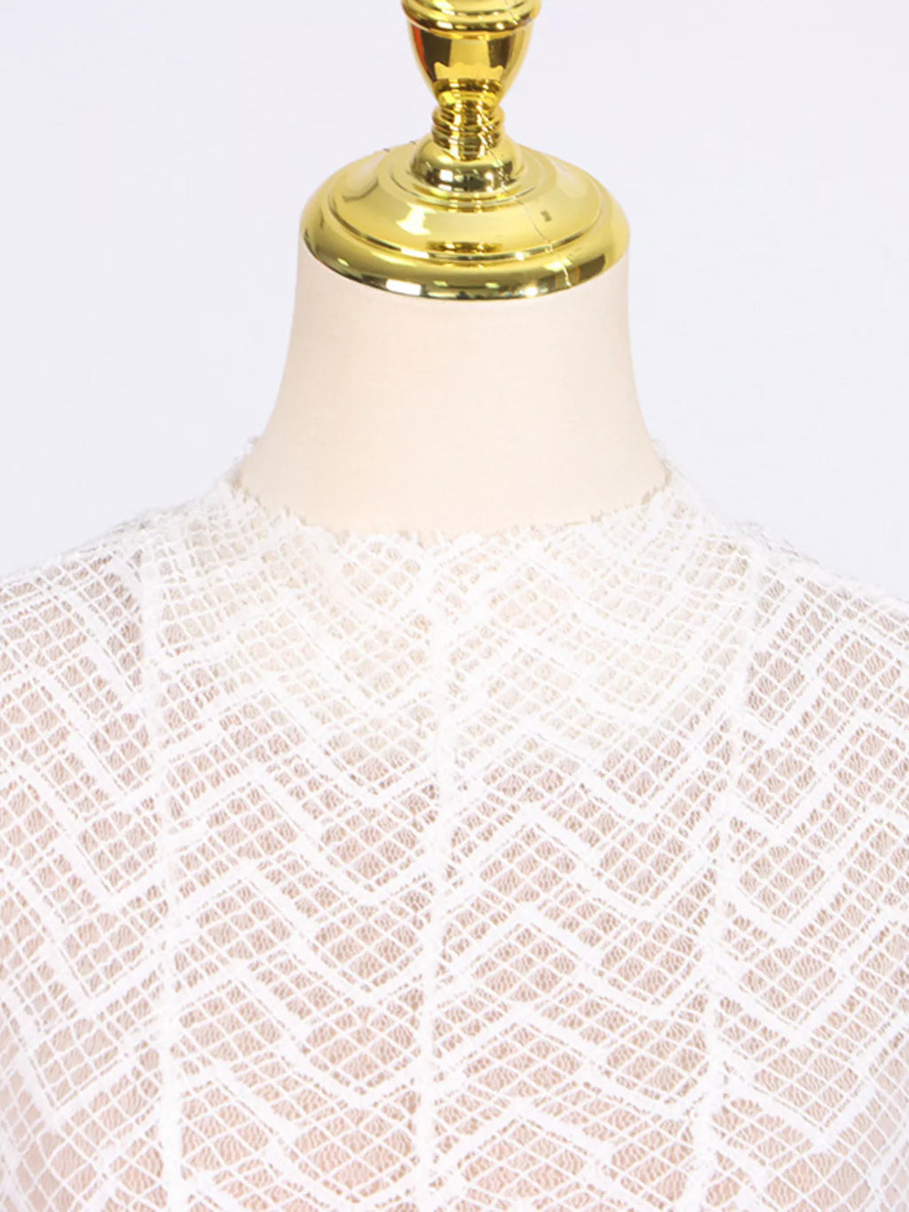 White textured-lace mock-neck maxi dress, lifestyle view showing the dress in movement.