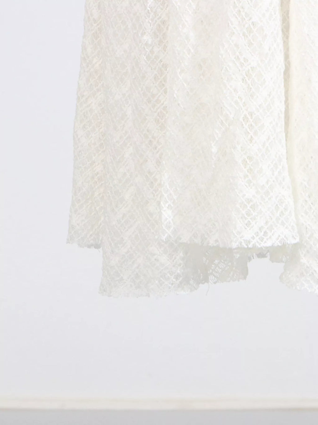 White lace mock-neck long-sleeve maxi dress, fabric and texture close-up showing the open-knit lace.