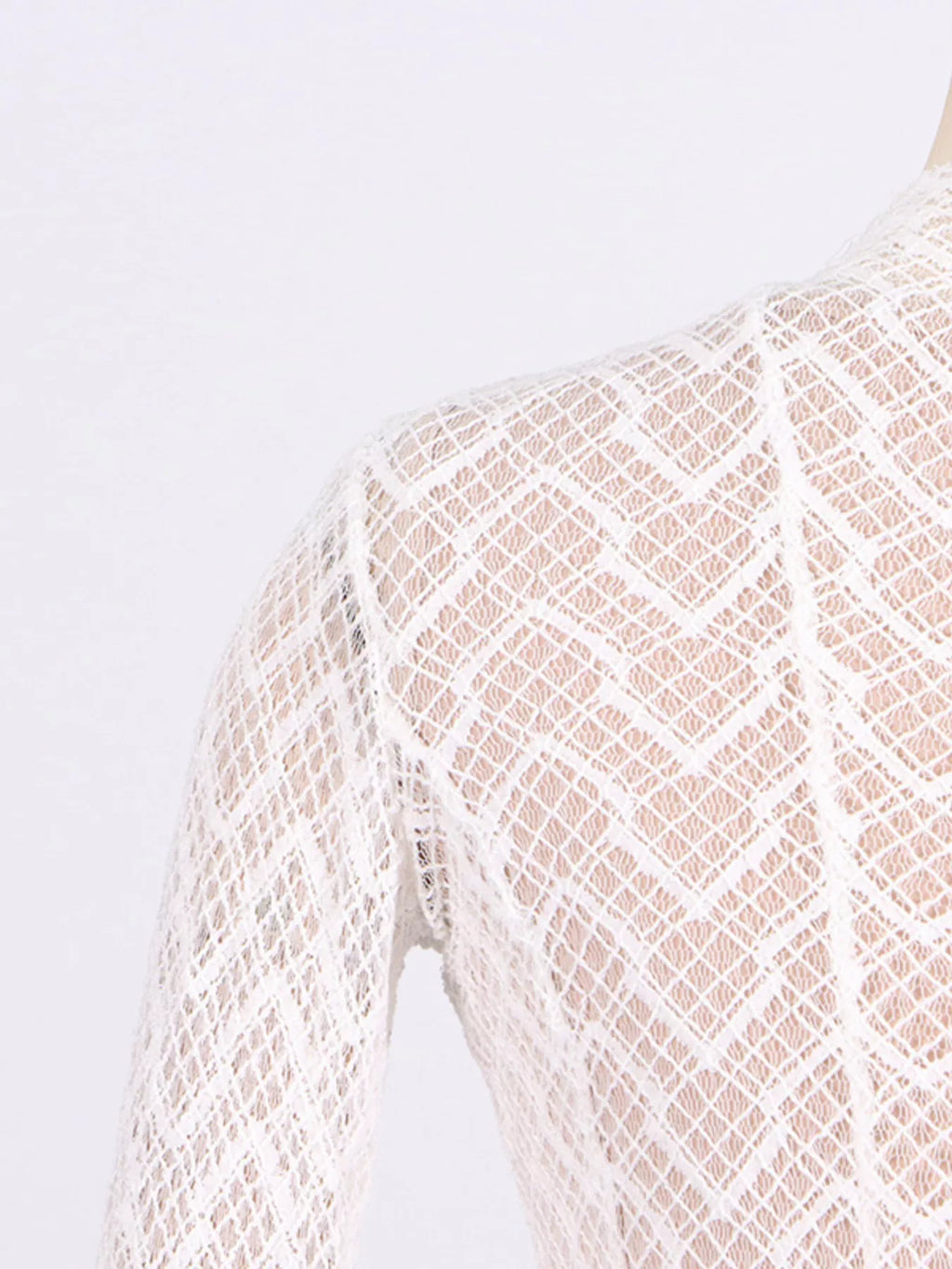 White textured-lace maxi dress, sleeve cuff detail showing the fluted finish and open-knit texture.